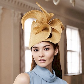 Gold fascinator hat wedding guest